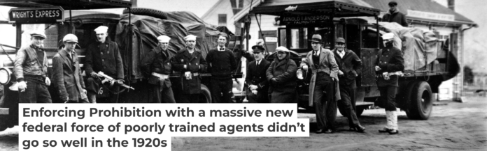 Coast Guardsmen stand in front of two truckloads of liquor seized on April 14, 1931, after a battle between three policemen and several alcohol smugglers near Falmouth, Mass. AP Photo